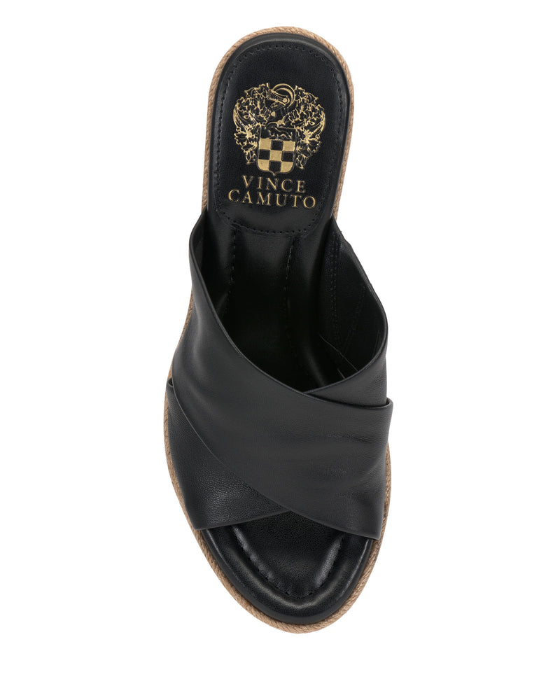 The Vince Camuto Fisella Espadrille Wedge Sandal features crisscross leather straps, an open toe, slip-on design, and a gold crest logo on the insole; shown from above against a white background.