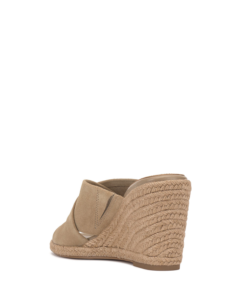The Vince Camuto Fisella Espadrille Wedge Sandal features a tan suede wide strap and braided espadrille platform heel, shown from the back and side against a white background.