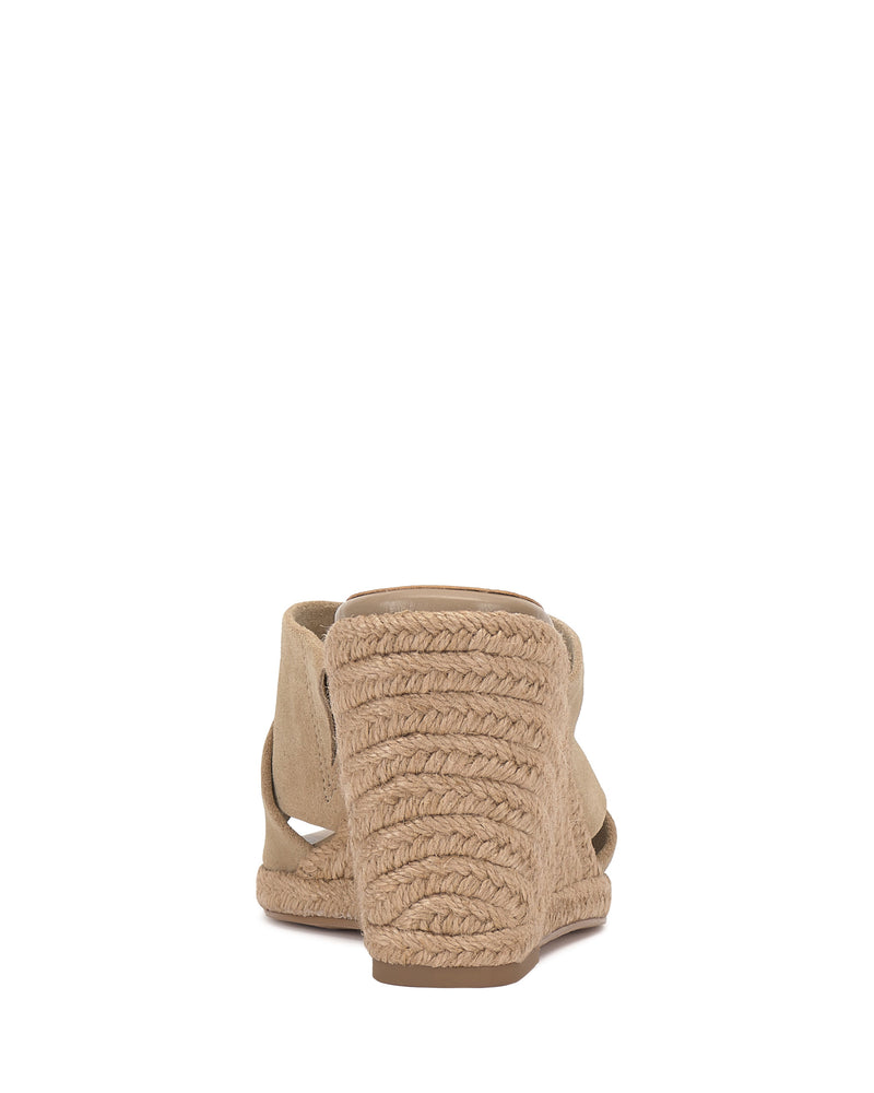 Rear view of the Vince Camuto Fisella Espadrille Wedge Sandal in beige, featuring braided rope detailing on the platform heel and a light brown sole, set against a white background.