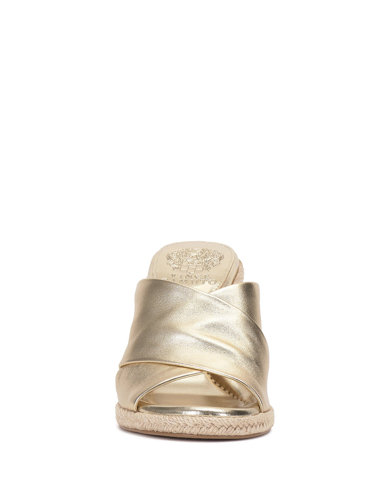 Front view of the Vince Camuto Fisella Espadrille Wedge Sandal in gold metallic with crisscrossed straps, open toe, espadrille platform sole, slip-on design, and an insole embossed with a decorative logo.