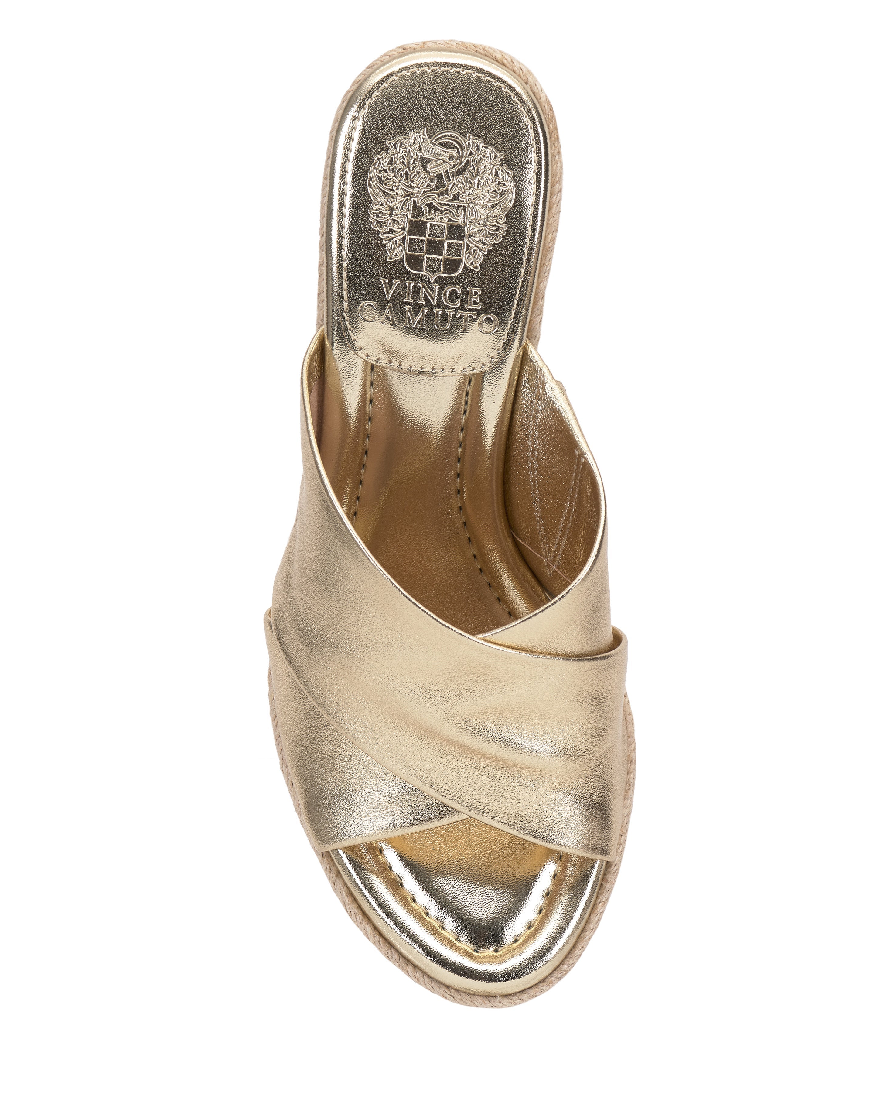 The Vince Camuto Fisella Espadrille Wedge Sandal features gold crisscross straps, an open toe, a metallic insole with logo near the heel, and a comfortable slip-on design for easy wear.