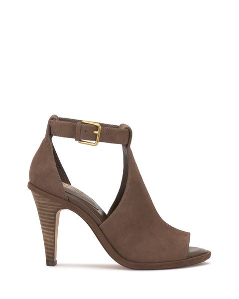 The Frasper Shootie by Vince Camuto is a brown suede high-heeled T-strap sandal featuring an open toe, open heel, ankle strap with gold buckle, cushioned footbed, and stacked wooden heel, displayed on a plain white background.