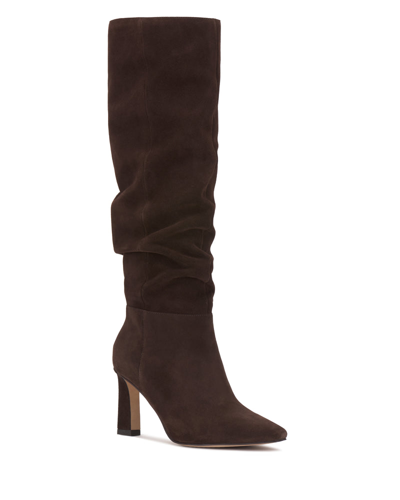 The Genisa Extra Wide Calf Slouchy Knee High Boot by Vince Camuto is shown as a single tall, brown suede boot featuring a pointed toe, slouchy shaft, and block heel against a white background.