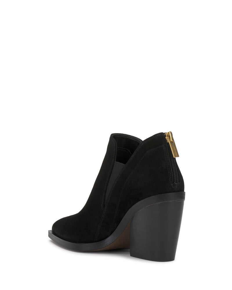 The Vince Camuto Gradina Bootie is a black suede ankle boot featuring a chunky high heel, side elastic panel, and a gold zipper at the back, displayed at an angle against a white background.