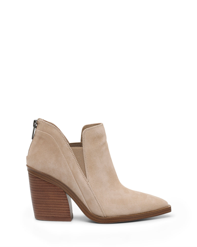 Rewritten sentence: The Gradina Bootie by Vince Camuto is a beige suede ankle boot with a pointed toe, a high stacked wooden heel similar to classic women’s ankle boots with a block heel, and features a stylish side cutout along with a visible back zipper.