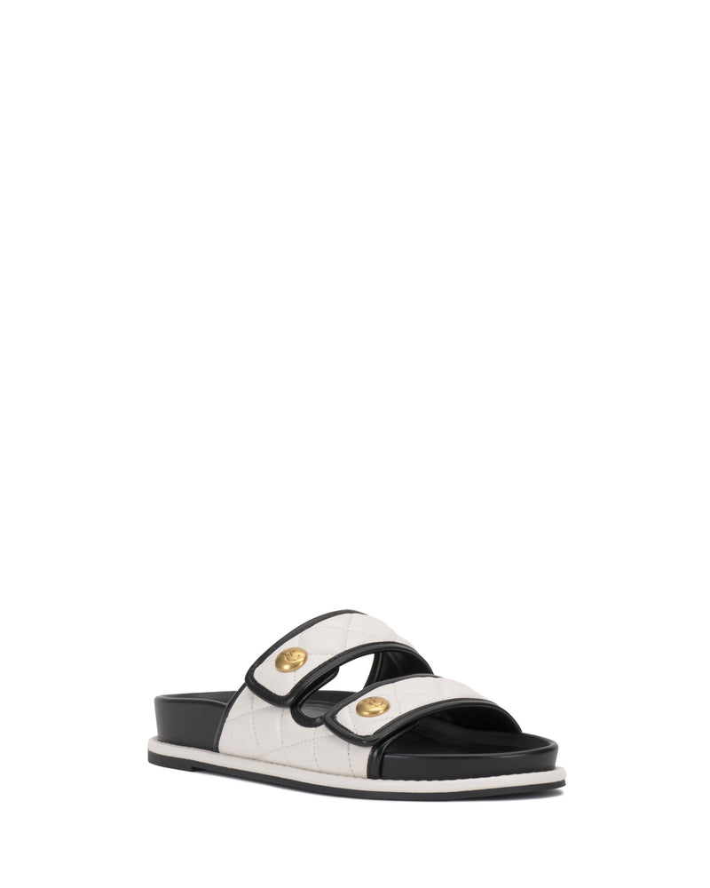 The Graysin Slide by Vince Camuto features a black and white double strap design with quilted upper, gold-toned buttons on each strap, a black sole, and white stitching.