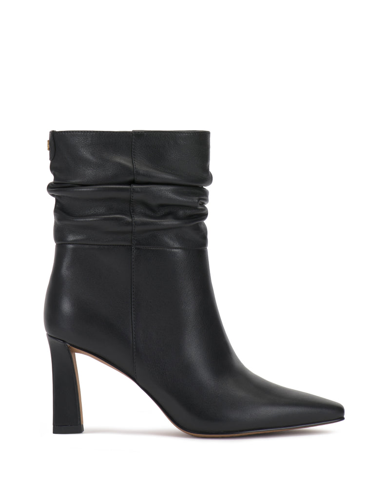 The Grenna Slouchy Bootie by Vince Camuto is a black leather ankle boot featuring a pointed toe, slouchy upper, and high block heel, displayed in side profile against a white background.