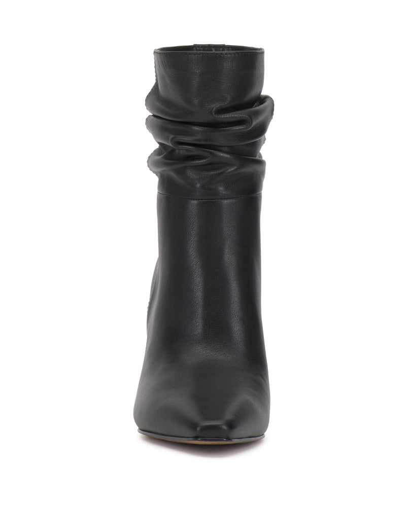 Front view of the Vince Camuto Grenna Slouchy Bootie in black leather, featuring a mid-calf height, slightly pointed toe, and smooth texture, standing upright on a white background.