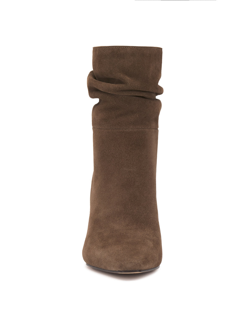 Front view of the Vince Camuto Grenna Slouchy Bootie in brown suede, featuring a slightly slouched shaft and rounded toe, photographed against a white background.