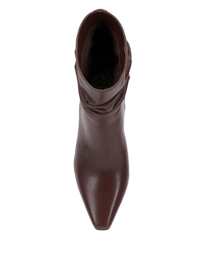 Top view of the Vince Camuto Grenna Slouchy Bootie, featuring a single brown leather boot with a pointed toe and slightly slouched shaft, displayed on a white background.