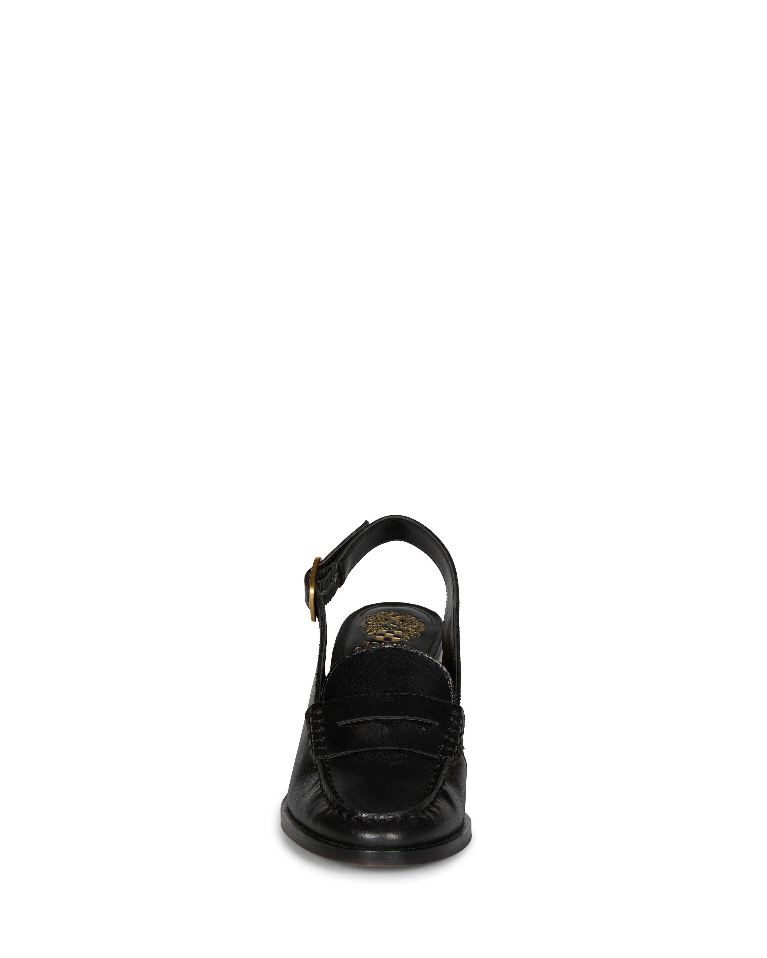 Front view of the Vince Camuto Grinie Loafer in black leather, featuring a closed toe, penny slot detail, ankle strap with a gold buckle, and chunky block heel, set against a plain white background.