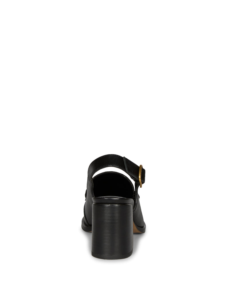 Back view of the Vince Camuto Grinie Loafer in black, showcasing a chunky block heel and an ankle strap with a gold buckle, set against a plain white background.