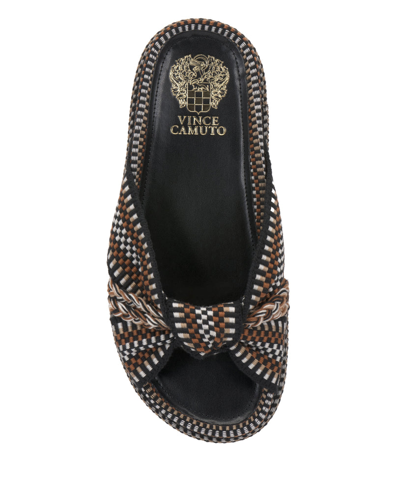 The Vince Camuto Gryfynn Slide features a black sole, multicolored checkered upper in brown, black, and white with a knotted top detail, cushioned for comfort, and gold Vince Camuto branding on the insole.
