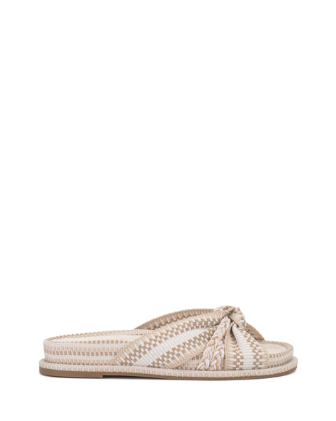 The Gryfynn Slide by Vince Camuto is a chic slip-on sandal with a flat cushioned sole, open toe, and a beige and white striped woven knotted strap across the top for effortless style.
