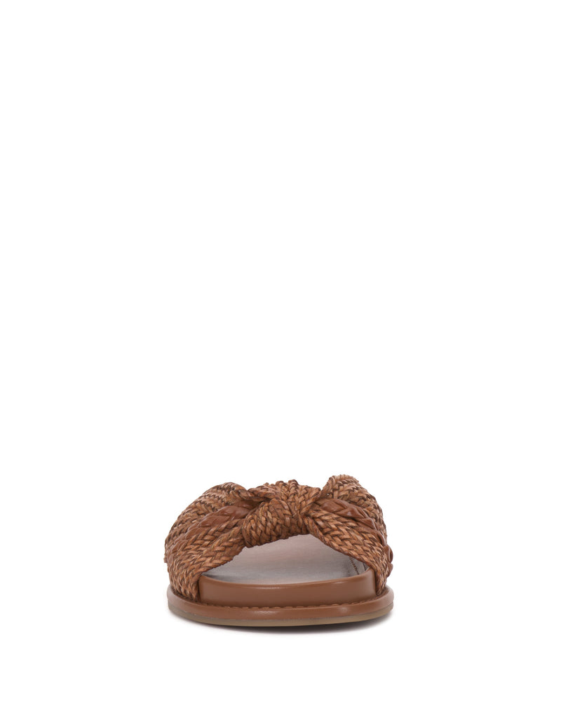 Front view of the Vince Camuto Gryfynn Slide, featuring brown braided straps in a knot design across the top and a flat, cushioned sole.