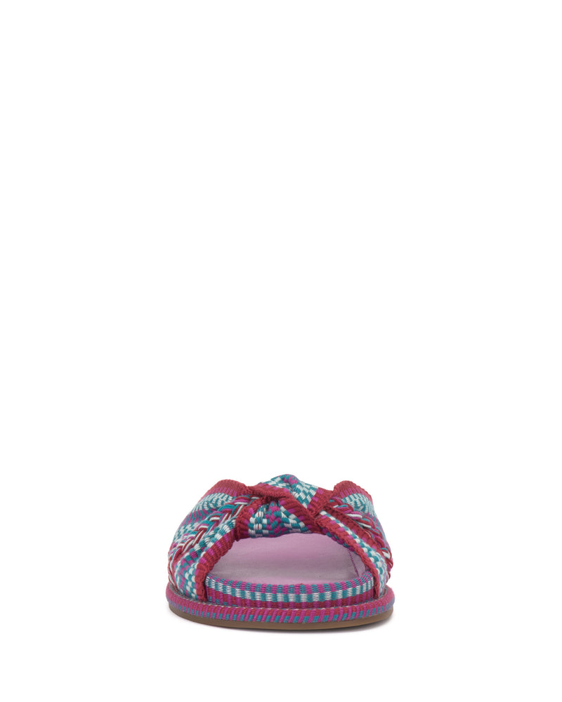 The Vince Camuto Gryfynn Slide features braided red, blue, and purple straps over a pink cushioned footbed for a vibrant summer style, shown from the front against a white background.