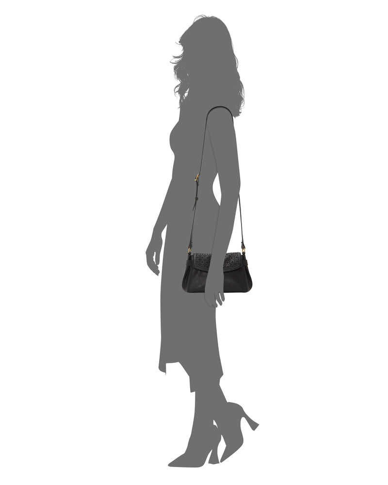 Silhouette of a woman in a mid-length dress and heels carrying the Vince Camuto Hadley Crossbody Bag, featuring a strap and gold hardware. The image showcases the handbag’s size and stylish design.