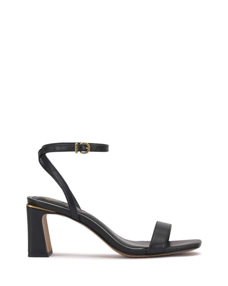 The Vince Camuto Hamda Sandal is a black block-heel shoe with a minimalist design, featuring a thin adjustable ankle strap with a small buckle and a single toe strap, shown in side profile on a white background.