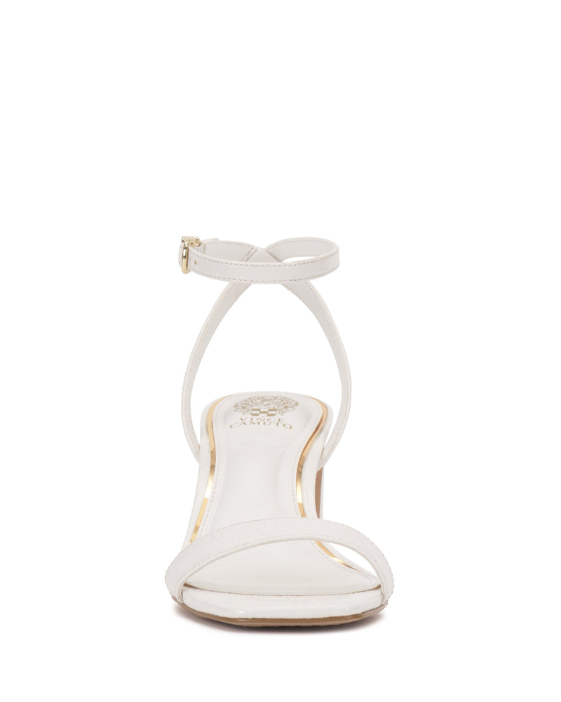 Front view of the Vince Camuto Hamda Sandal in white, featuring a minimalist design with a thin adjustable ankle strap, single toe strap, low heel, and gold-detailed branded insole. Shown on a plain white background.