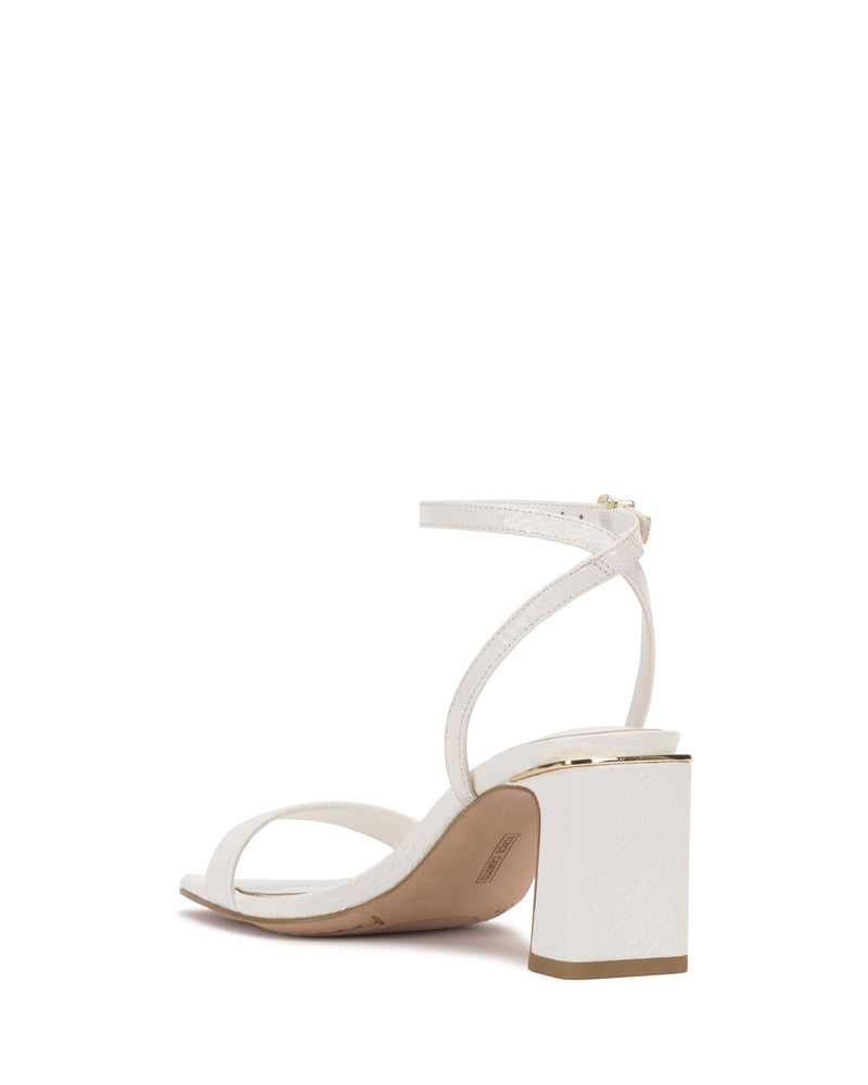 The Vince Camuto Hamda Sandal is a white, open-toe block heel with a minimalist design and adjustable ankle strap with buckle, shown from the back against a plain white background.