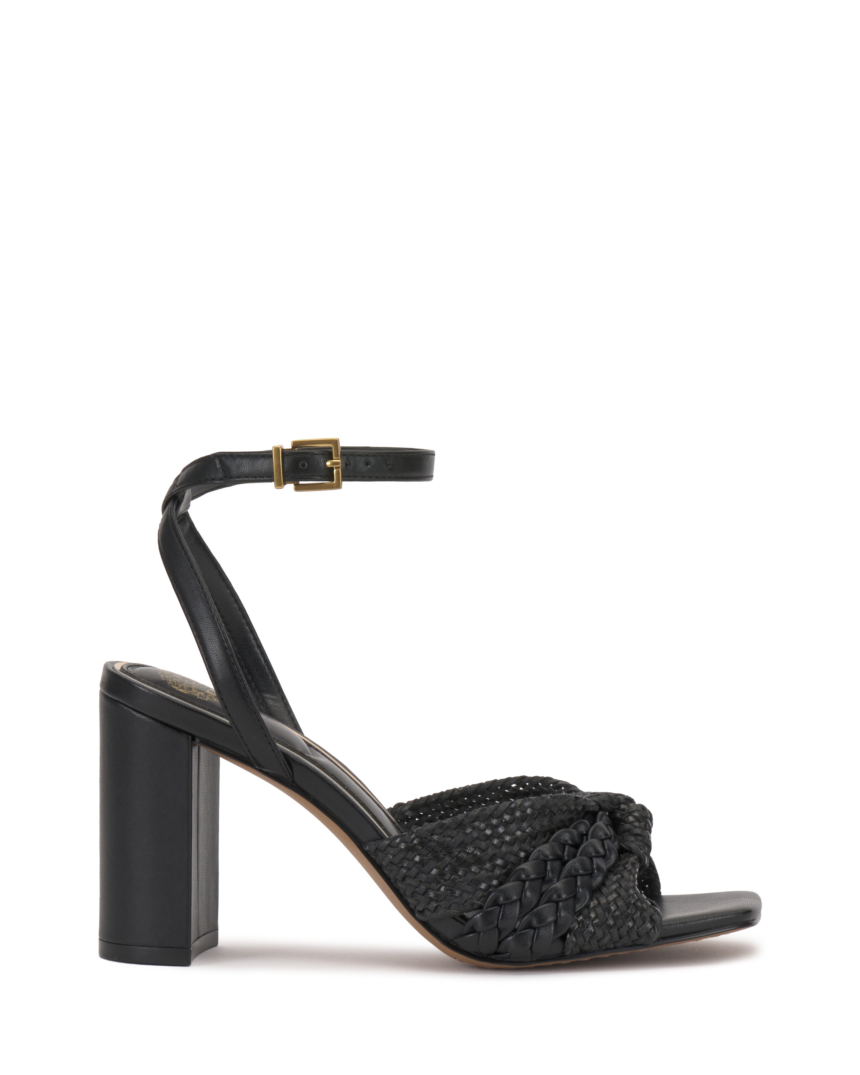 The Vince Camuto Hanlea Sandal showcases a black braided leather front strap, closed back, ankle strap with gold buckle, and a thick block heel for stylish support.