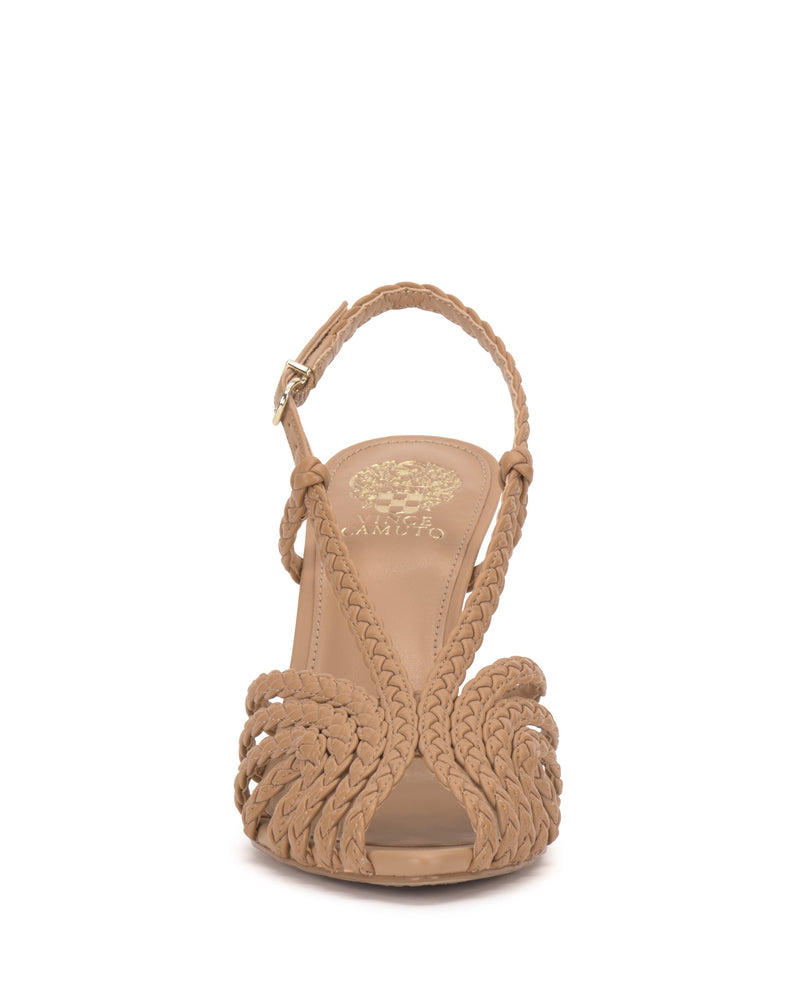 Front view of the Vince Camuto Hannie Slingback Sandal in beige, featuring braided straps, ankle buckle, open toe with caged design, and a gold floral logo on the insole.