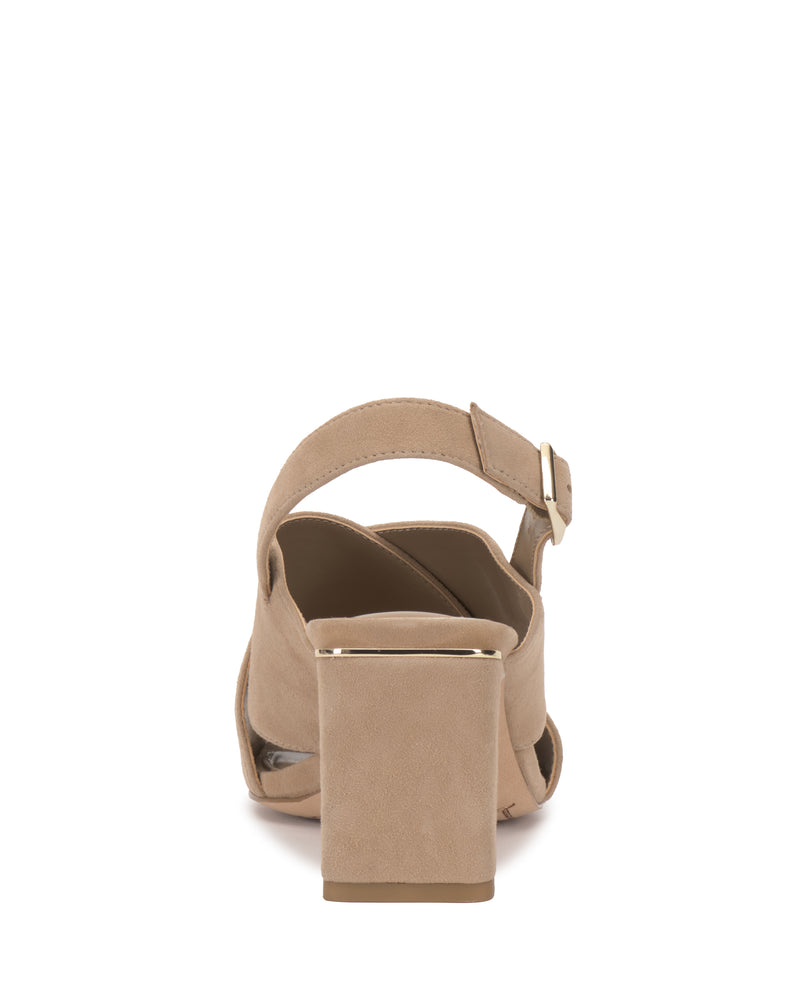 Rear view of the Vince Camuto Harlynn Sandal in beige suede, featuring a slingback design with a block heel, ankle strap, and gold buckle detail. The top edge of the heel is accented with gold for a signature touch.
