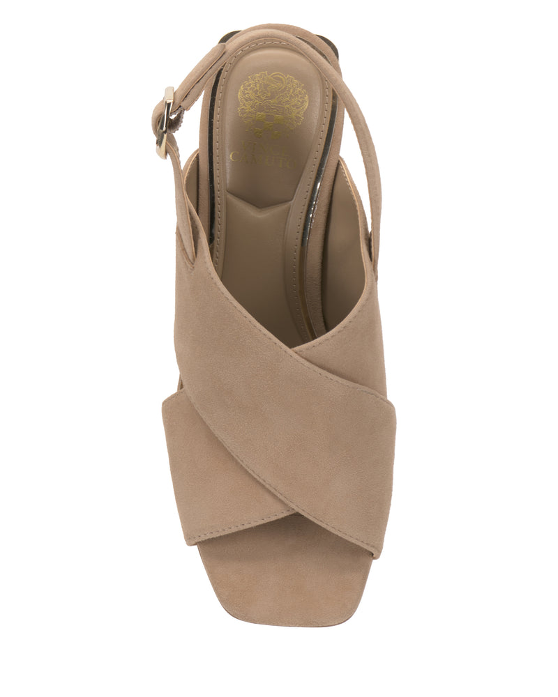 The Harlynn Sandal by Vince Camuto features a beige suede cross-band slingback design with crisscross straps, a block heel, silver buckle, and a square open toe—seen from above, this chic pair elevates any look.