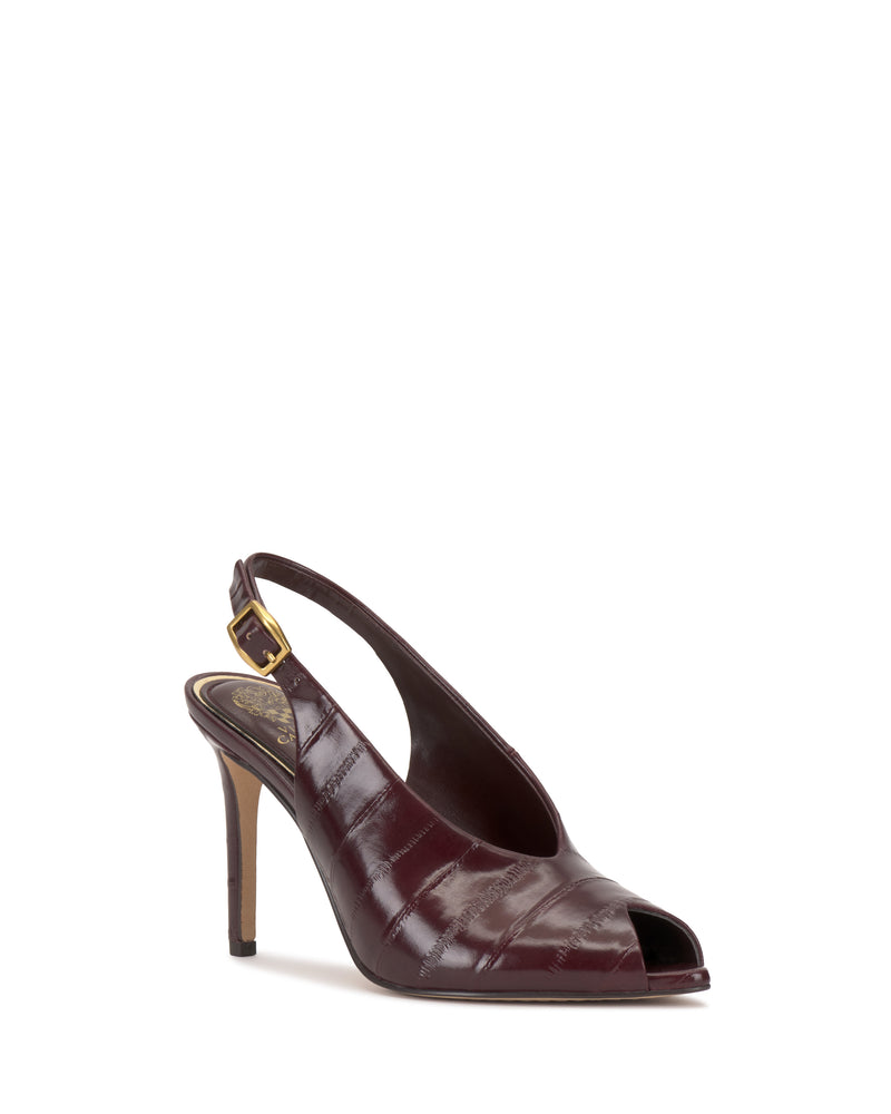 The Helenza Pump by Vince Camuto is a burgundy high-heeled slingback with a peep toe and gold buckle, featuring a glossy, textured finish and an elegant skinny heel.