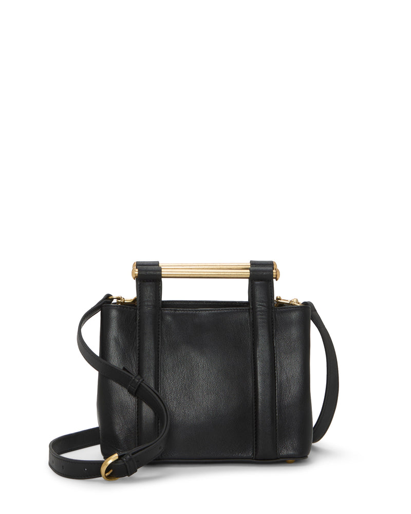 The Jayda Satchel Bag by Vince Camuto is a small black leather bag featuring a gold metal bar handle and adjustable strap, shown on a plain white background.