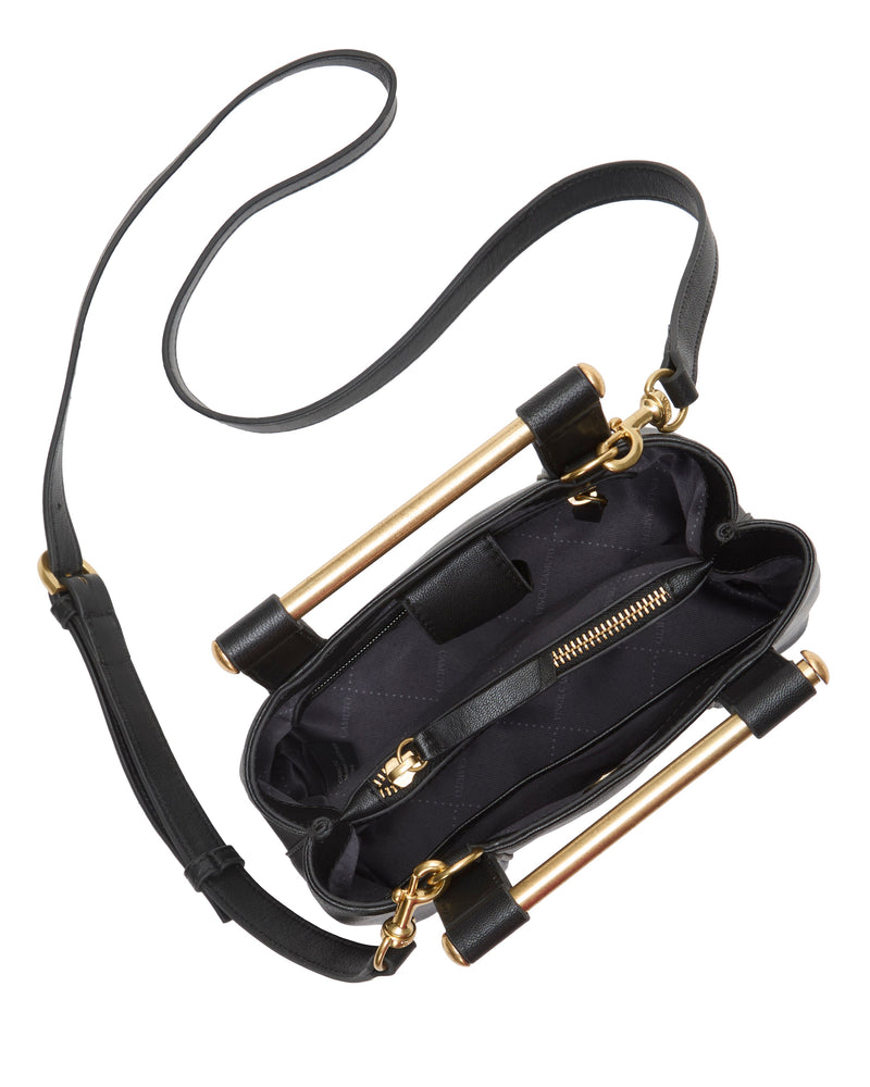 A top view of the Vince Camuto Jayda Satchel Bag showcases its black leather design, gold metal bar handles, long shoulder strap, and open interior featuring a zippered pocket and lining.