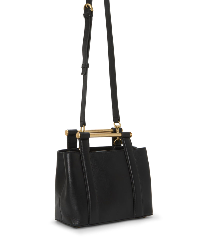 The Jayda Satchel Bag from Vince Camuto is a black leather accessory with a structured rectangular design, gold-tone metal frame at the top, and an adjustable shoulder strap.