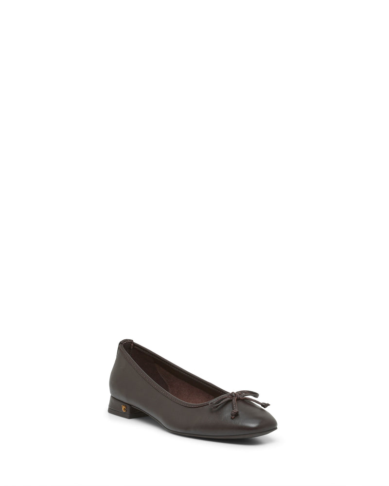 The Vince Camuto Jenlea Ballet Flat is a single dark brown leather shoe featuring a low block heel and a delicate bow accent on the toe, displayed on a white background.