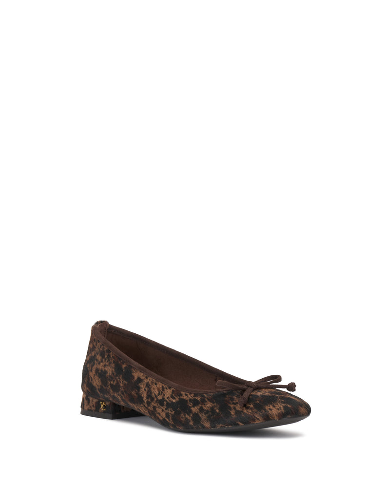 The Jenlea Ballet Flat by Vince Camuto features a brown and black animal print design with a small bow on the front and a low heel, showcased against a white background.
