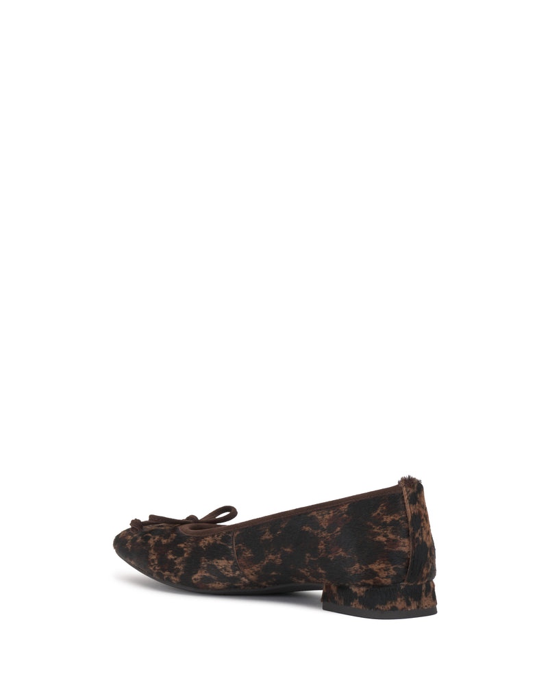 The Jenlea Ballet Flat by Vince Camuto is a single dark brown and black patterned flat shoe featuring a small block heel and a bow detail on the toe, displayed against a white background.
