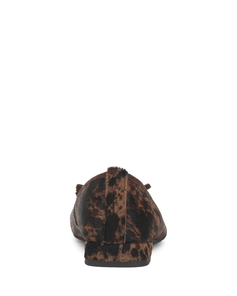 Back view of the Vince Camuto Jenlea Ballet Flat, featuring a brown and black animal print and a small tail-like detail on the heel, set against a white background.