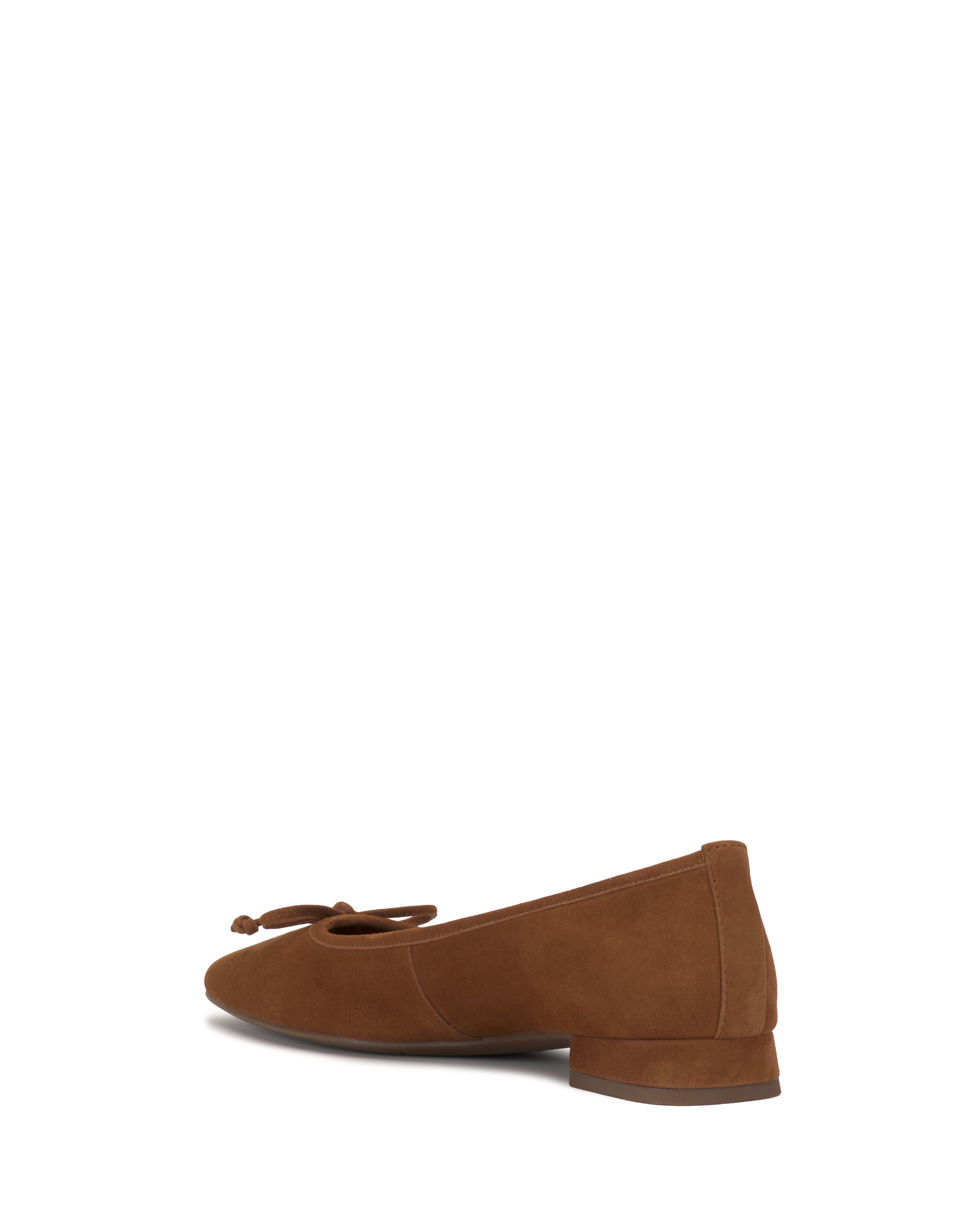 The Vince Camuto Jenlea Ballet Flat is a brown suede shoe featuring a small bow on the toe and a low block heel, shown against a white background.