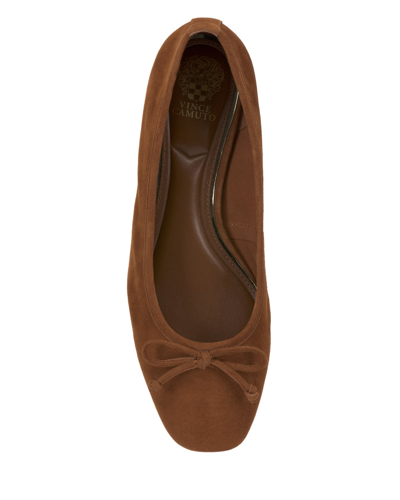 Top view of the Vince Camuto Jenlea Ballet Flat in brown suede, featuring a rounded square toe, a front bow, and a brown insole with the Vince Camuto logo near the heel.