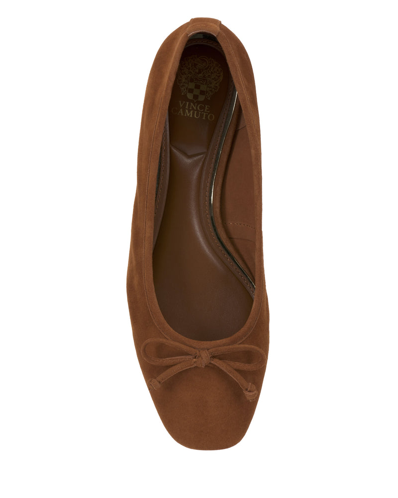 The Vince Camuto Jenlea Ballet Flat is a brown suede shoe featuring a rounded square toe, front bow accent, and cushioned insole, shown from above.