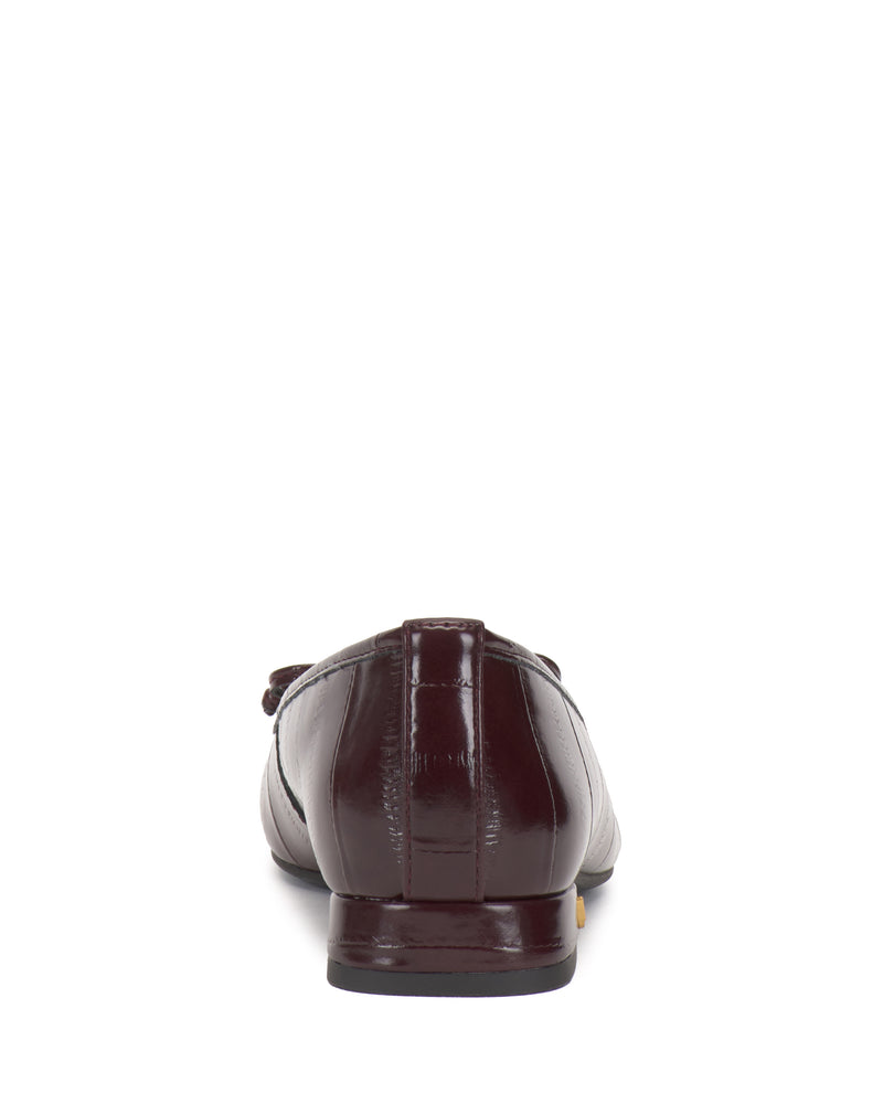 Back view of a single Vince Camuto Jenlea Ballet Flat in dark brown leather with a flat heel, shown on a white background.