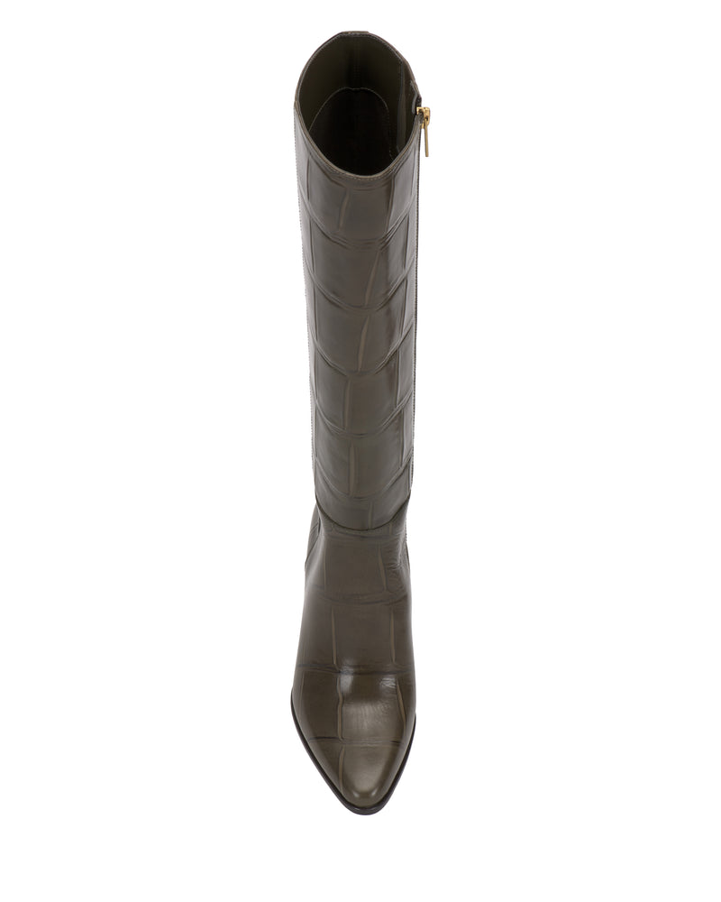 The Vince Camuto Jorela Narrow Calf Knee High Boot is crafted from dark olive green leather with a crocodile pattern, featuring a pointed toe and side zipper, shown from above against a white background.