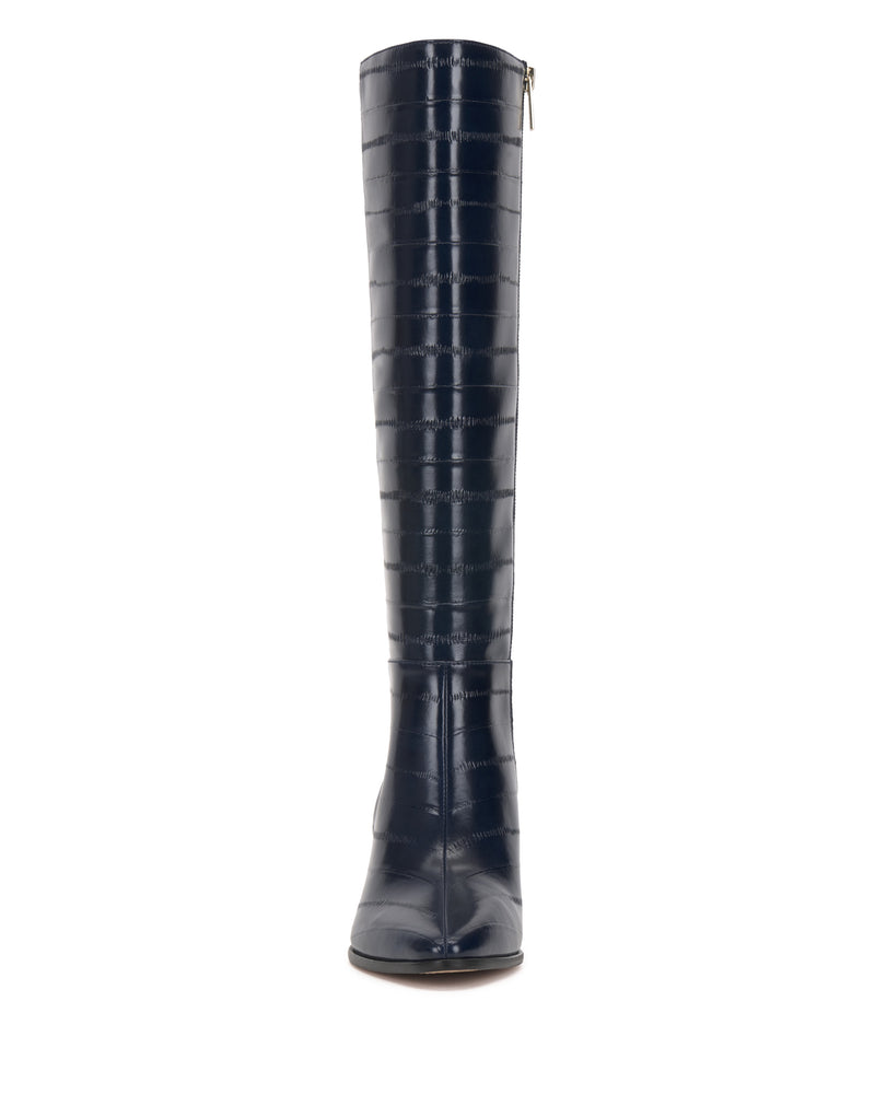 Front view of the Vince Camuto Jorela Narrow Calf Knee High Boot in tall, dark blue, crocodile-textured leather with a pointed toe and side zipper, shown against a white background.