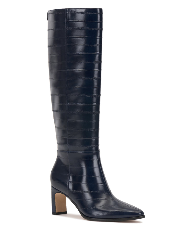The Jorela Wide Calf Knee High Boot by Vince Camuto is a single navy blue leather boot with a pointed toe and a chunky mid-height heel, showcasing a subtle horizontal pattern and a smooth finish.