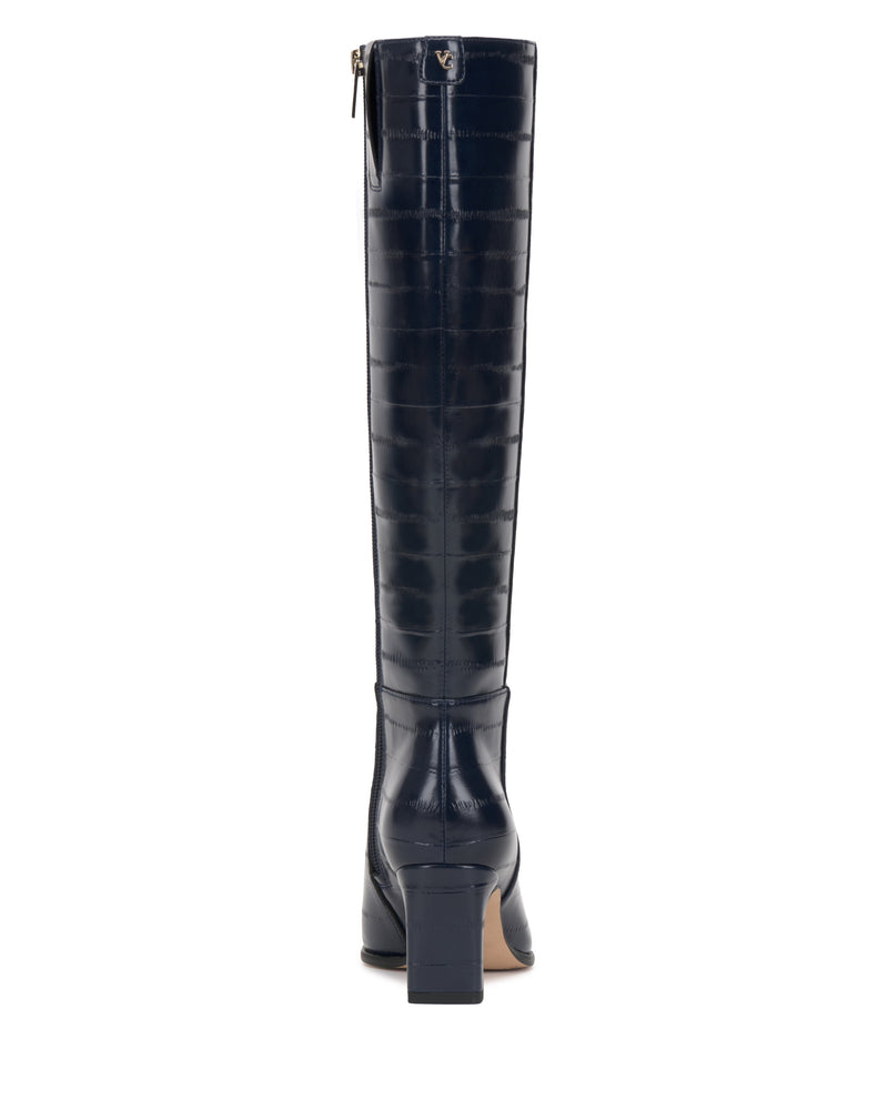 The Vince Camuto Jorela Extra Wide Calf Knee High Boot in dark navy features a crocodile skin texture and a square heel, shown from the back against a white background.