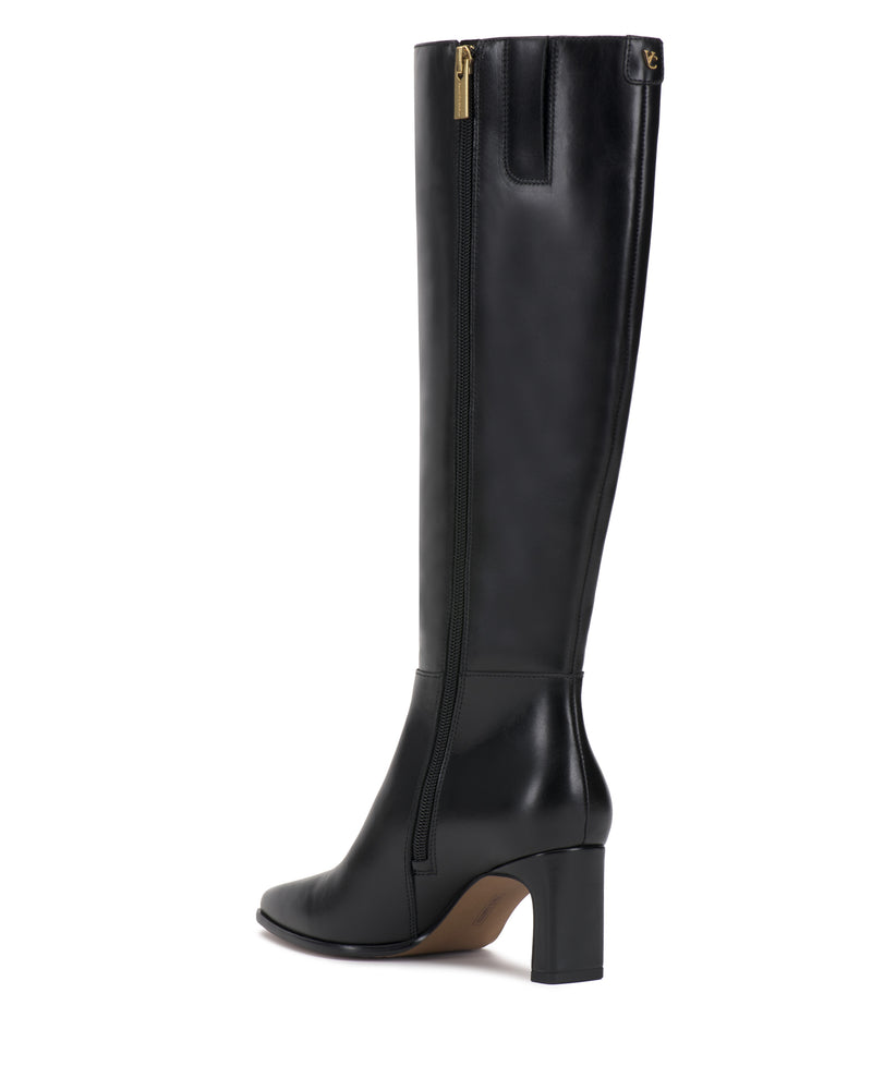 The Jorela Knee High Boot by Vince Camuto is a black leather knee-high boot featuring a side zipper, block heel, and gold hardware. Displayed against a white background, this boot showcases a sleek design with an almond-shaped toe.