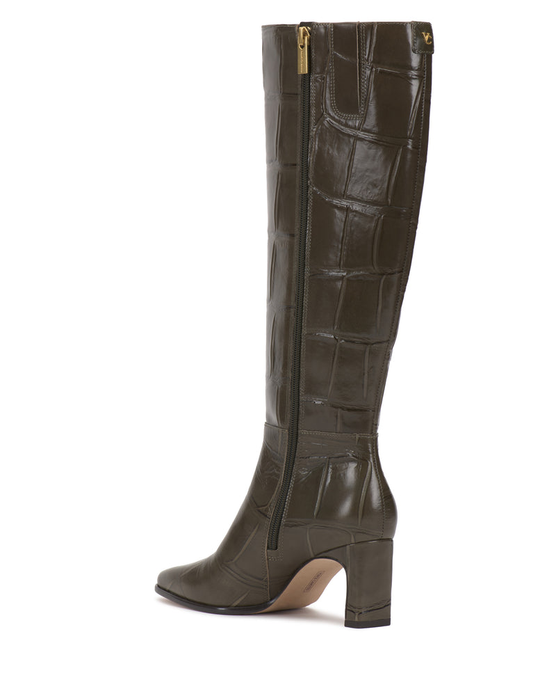 Side view of the Vince Camuto Jorela Knee High Boot, featuring tall, dark green crocodile-embossed leather, a block heel, pointed toe, and a side zipper.