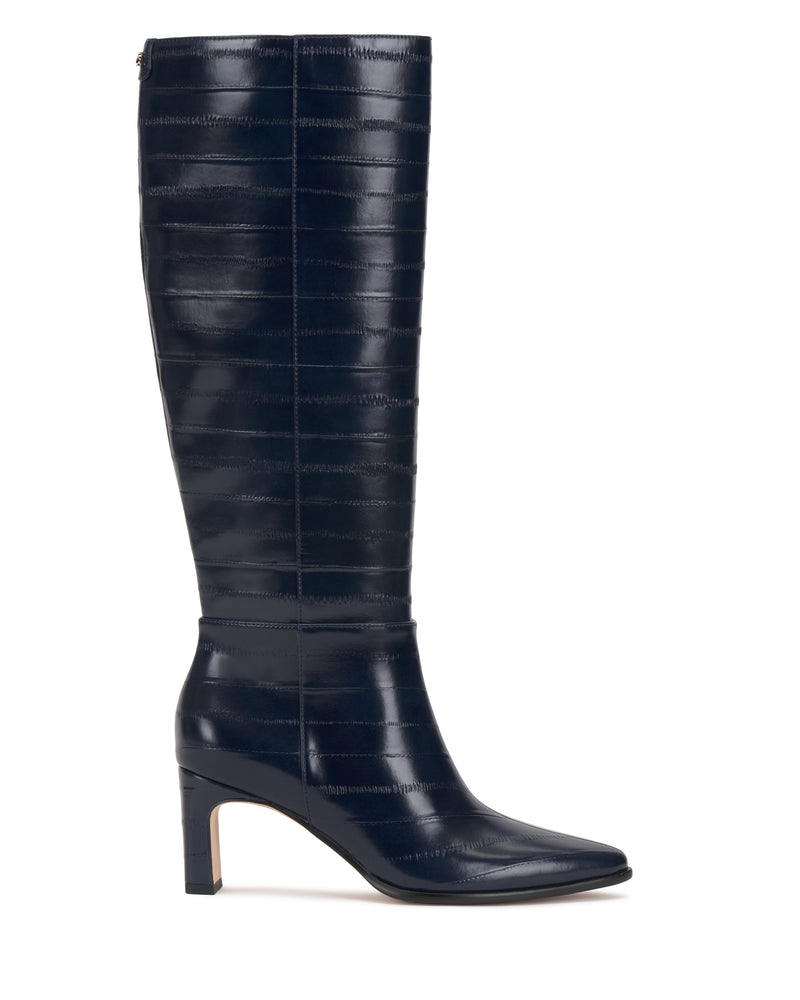 The Jorela Knee High Boot by Vince Camuto is a tall, dark navy leather boot featuring subtle horizontal stitching, a pointed toe, and a block heel.