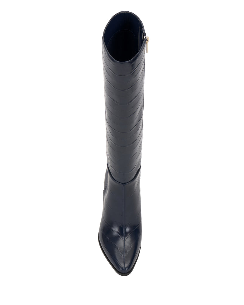 The Vince Camuto Jorela Knee High Boot in navy blue features a pointed toe and side zipper, shown from above against a white background.