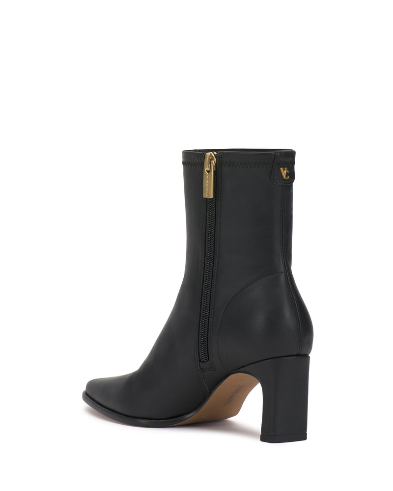 The Julea Bootie by Vince Camuto is a black heeled ankle boot featuring a gold zipper and a small gold logo near the top, displayed from a rear-side angle on a white background.