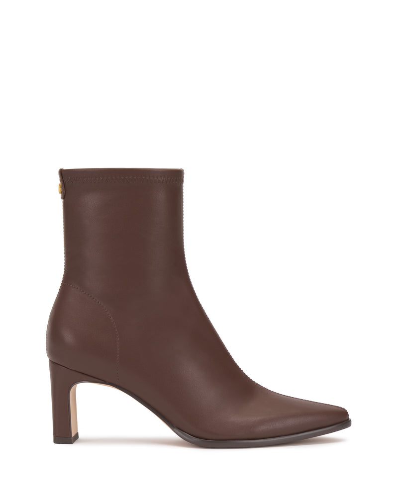 The Vince Camuto Julea Bootie is a brown leather ankle boot featuring a pointed toe, mid-height block heel, and subtle stitching details, displayed in profile against a white background.